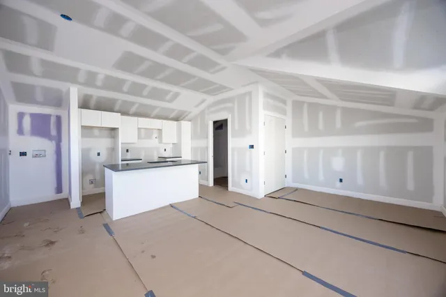 a multi story building with a tree in front of it