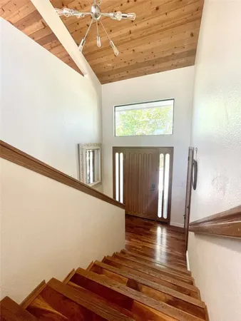 a view of a room with wooden floor and a window