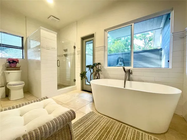 a spacious bathroom with a bathtub and shower