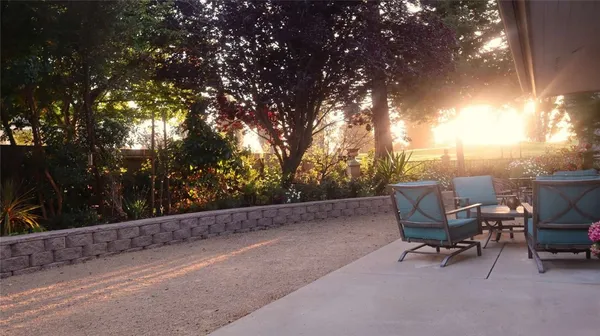 a view of a yard with furniture and sitting area