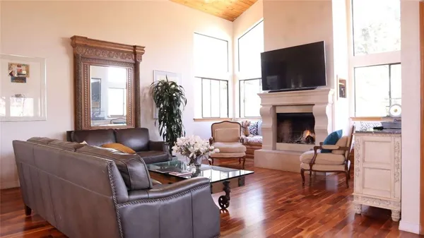 a living room with furniture fireplace and flat screen tv