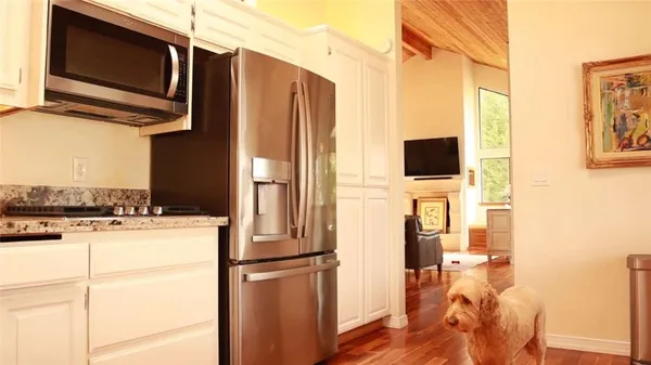 a kitchen with stainless steel appliances a refrigerator stove and microwave
