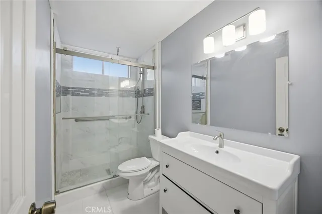 a bathroom with a sink a light fixture and a mirror