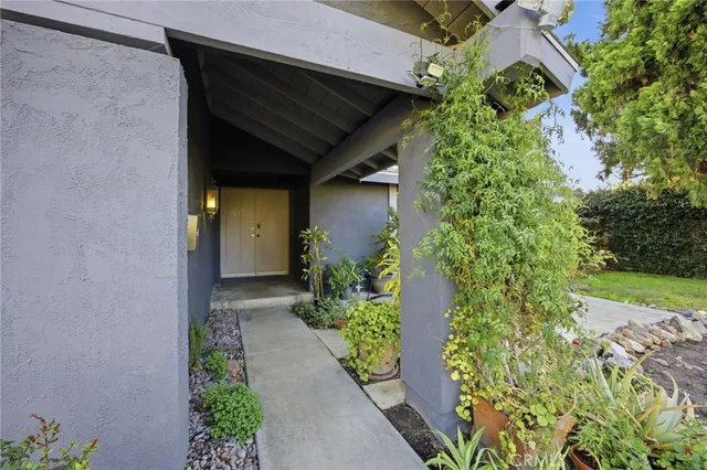 an entrance to house with yard and green space