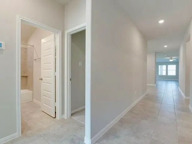 a view of a hallway with wooden floor