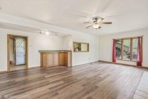 5718 West Small Road La Porte, IN 46350 - Photo 15 of 26 a view of an empty room with a window and wooden floor