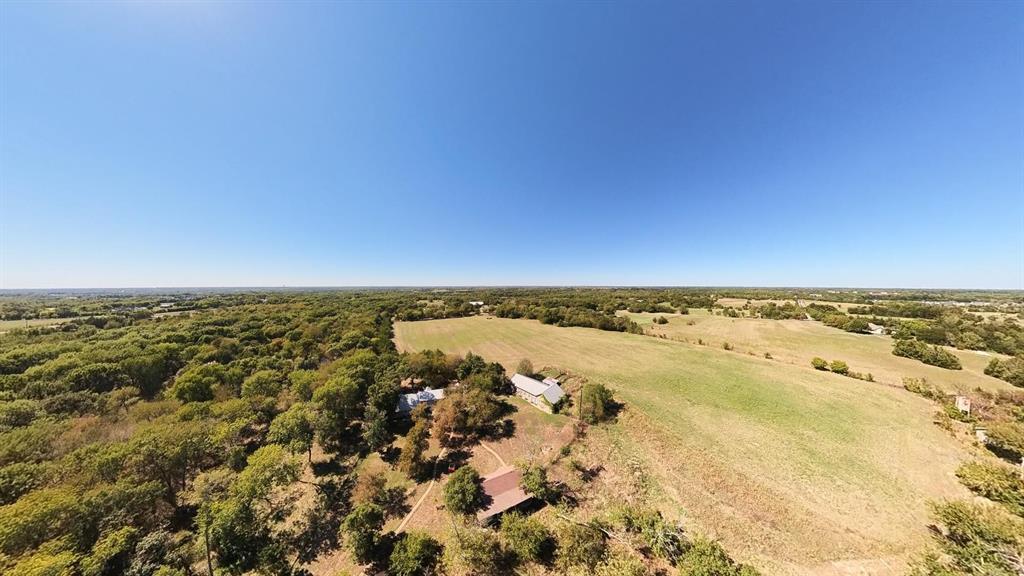 242 Oak Hill Road Van Alstyne, TX 75495 - Photo 3 of 10 Expansive rural landscape featuring a mix of mature trees, open fields, and residential structures