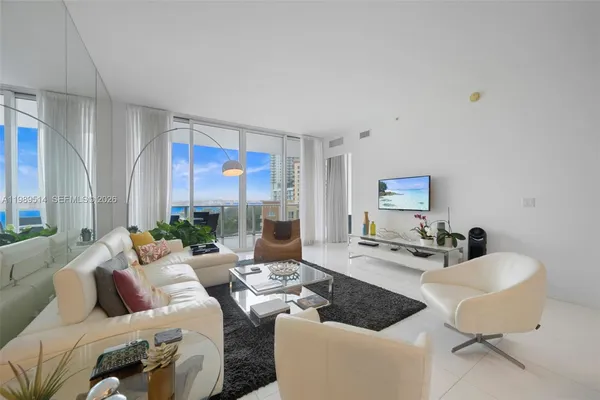 a living room with furniture and a large window