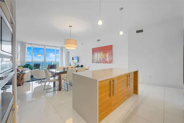 a view of kitchen with furniture and chandelier