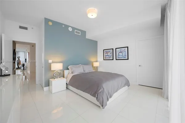 a bedroom with a bed and a lamp