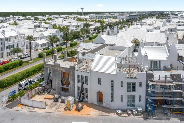 a dining room with furniture and a potted plant