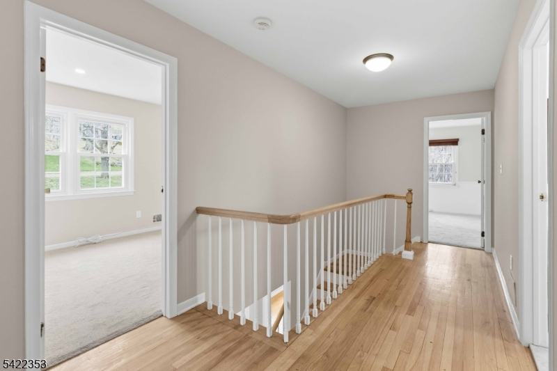 14 Beaver Ridge Road Morris Plains, NJ 07950 - Photo 18 of 39 a view of a hallway with wooden floor and a bathroom
