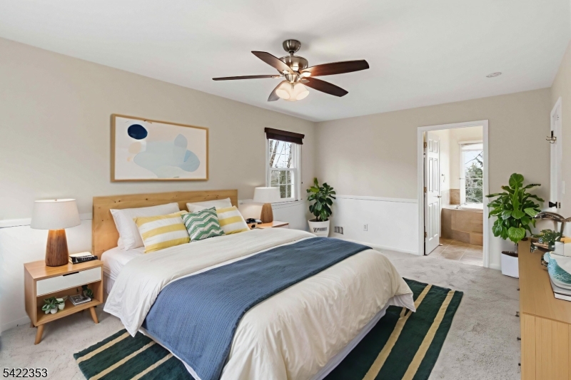 14 Beaver Ridge Road Morris Plains, NJ 07950 - Photo 20 of 39 a bedroom with a bed and a chandelier