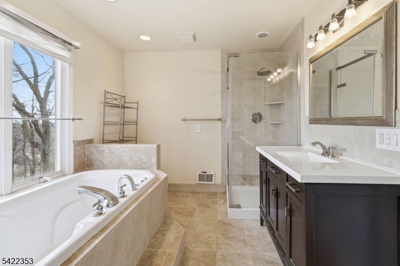 14 Beaver Ridge Road Morris Plains, NJ 07950 - Photo 25 of 39 a bathroom with a tub sink and mirror