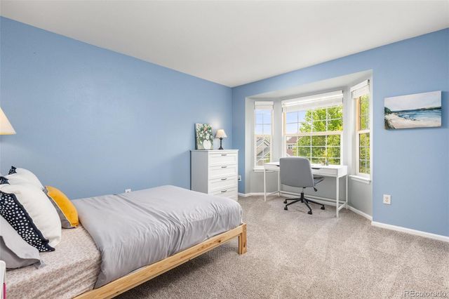 a bedroom with a bed and a desk