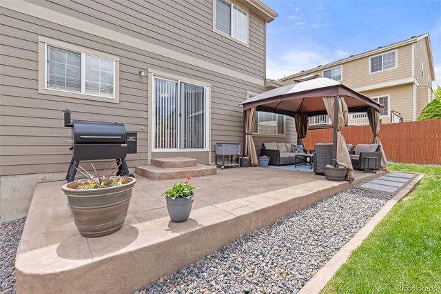 a view of a backyard with sitting area