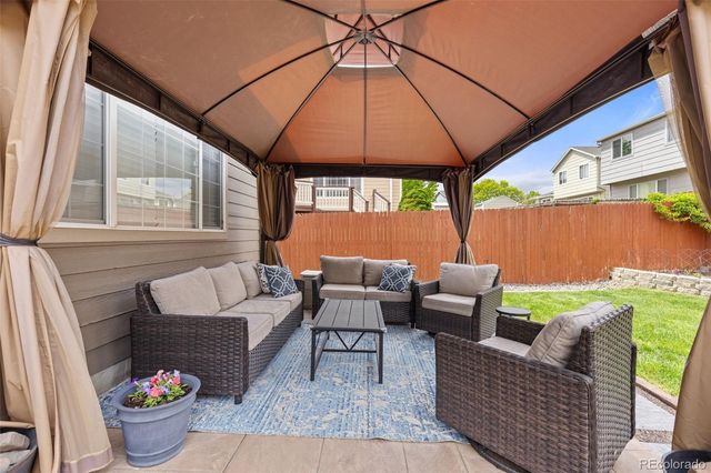 a outdoor living space with furniture and umbrella