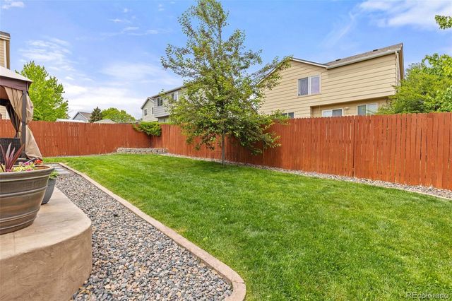 a view of backyard with swimming pool and outdoor seating