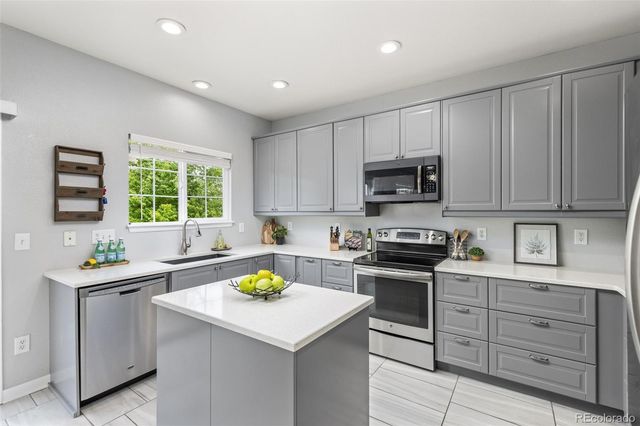 a kitchen with a sink stove and microwave