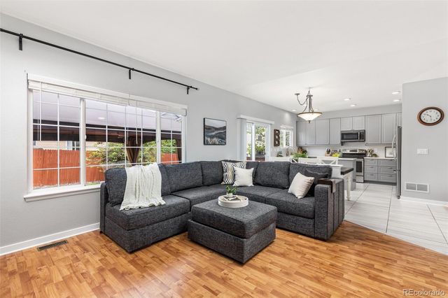 a living room with furniture window and wooden floor