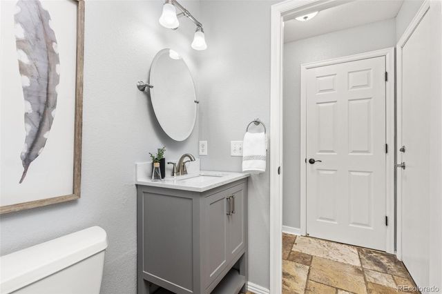 a bathroom with a sink a toilet and a mirror