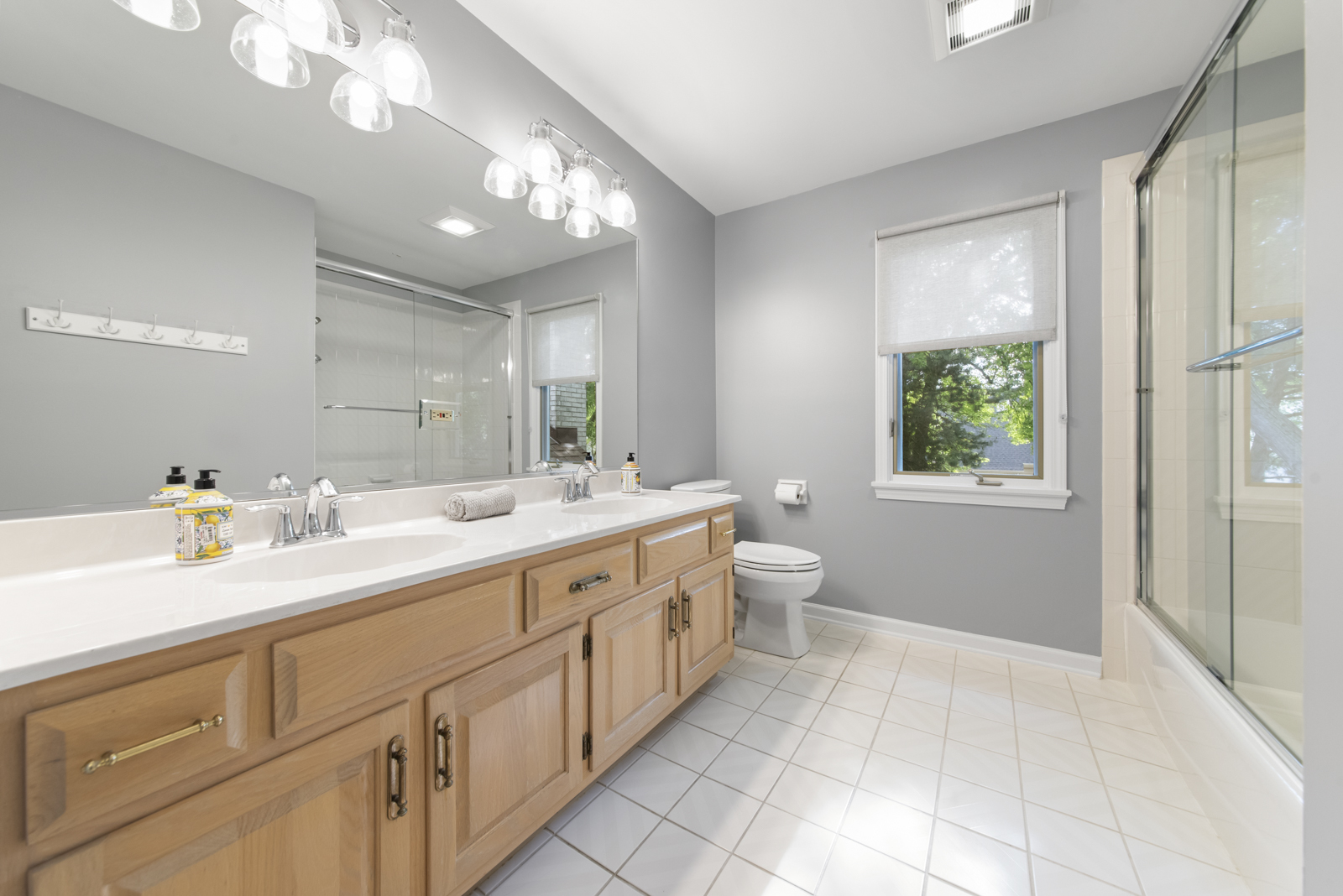 N440 Peter Road Winfield, IL 60190 - Photo 26 of 34 a spacious bathroom with a double vanity sink a large mirror and a toilet