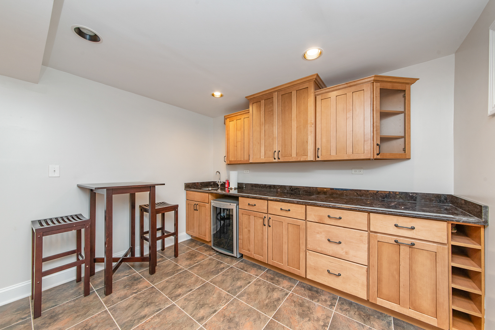 N440 Peter Road Winfield, IL 60190 - Photo 29 of 34 a kitchen with granite countertop a stove a sink cabinets and wooden floor