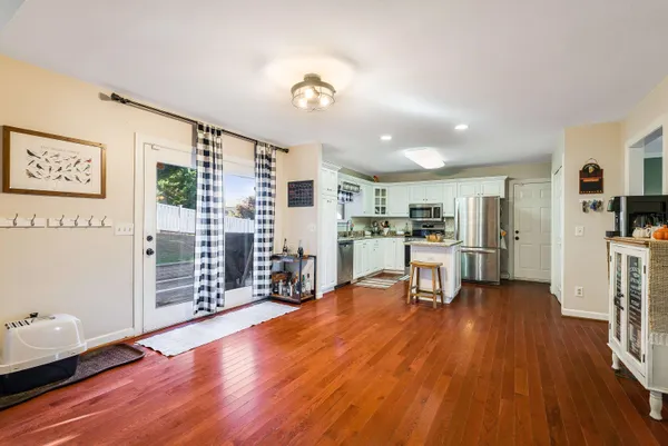 a bedroom with furniture and a wooden floor