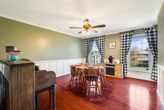 a view of a dining room with furniture wooden floor and a chandelier