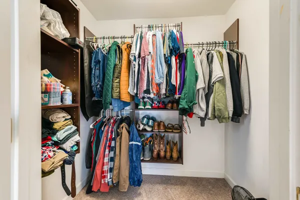 a spacious bedroom with a bed and a large window