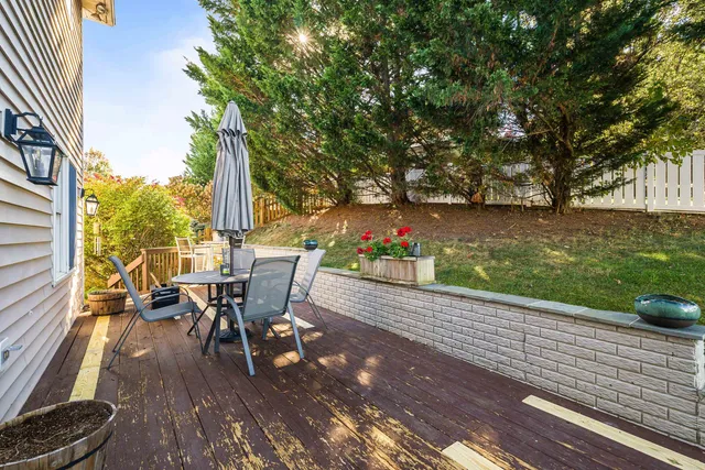 a view of a patio with table and chairs and floor to ceiling window