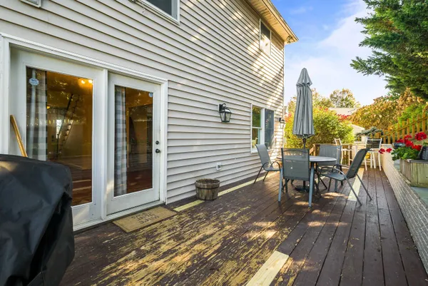 a view of a chair and tables in the balcony