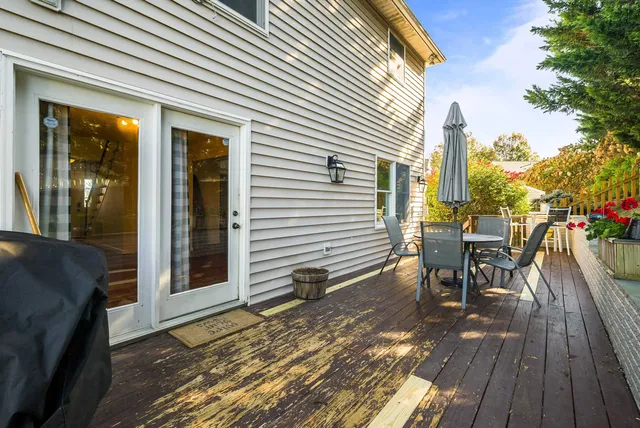 a view of a chair and tables in the balcony