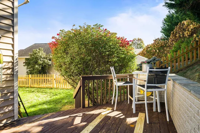 a view of a chair and table on the wooden deck