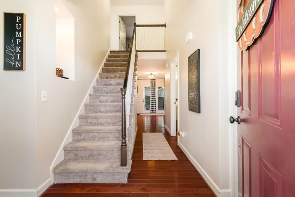 a view of an entryway with wooden floor and stairs