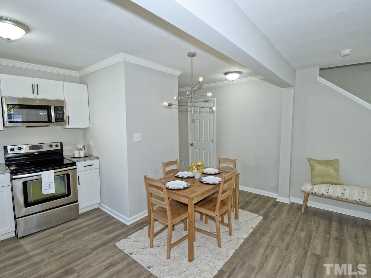 3606 Meriwether Drive Durham, NC 27704 - Photo 5 of 23 a kitchen with a table and chairs in it