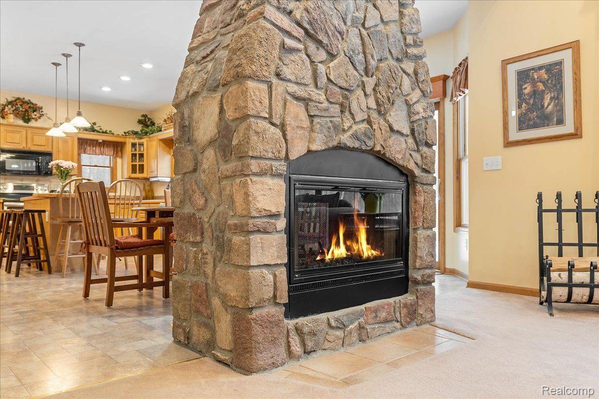 21851 Prince Road Belleville, MI 48111 - Photo 12 of 59 Double sided fireplace between living and dining
