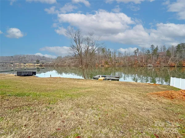 a view of a lake with houses in the back