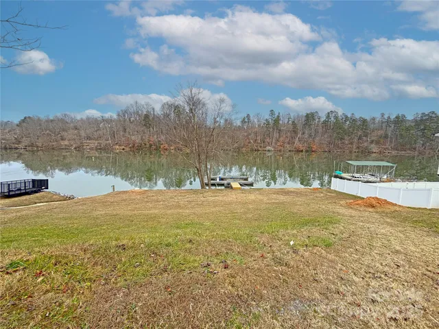 a view of a lake with houses in the back