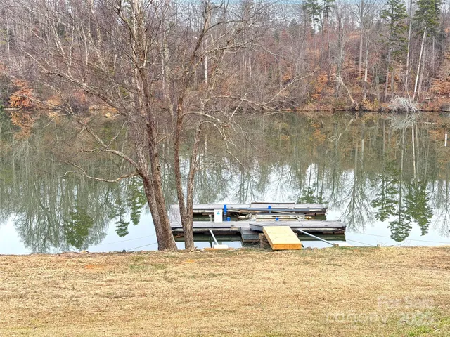 a view of a swimming pool with a patio and a yard