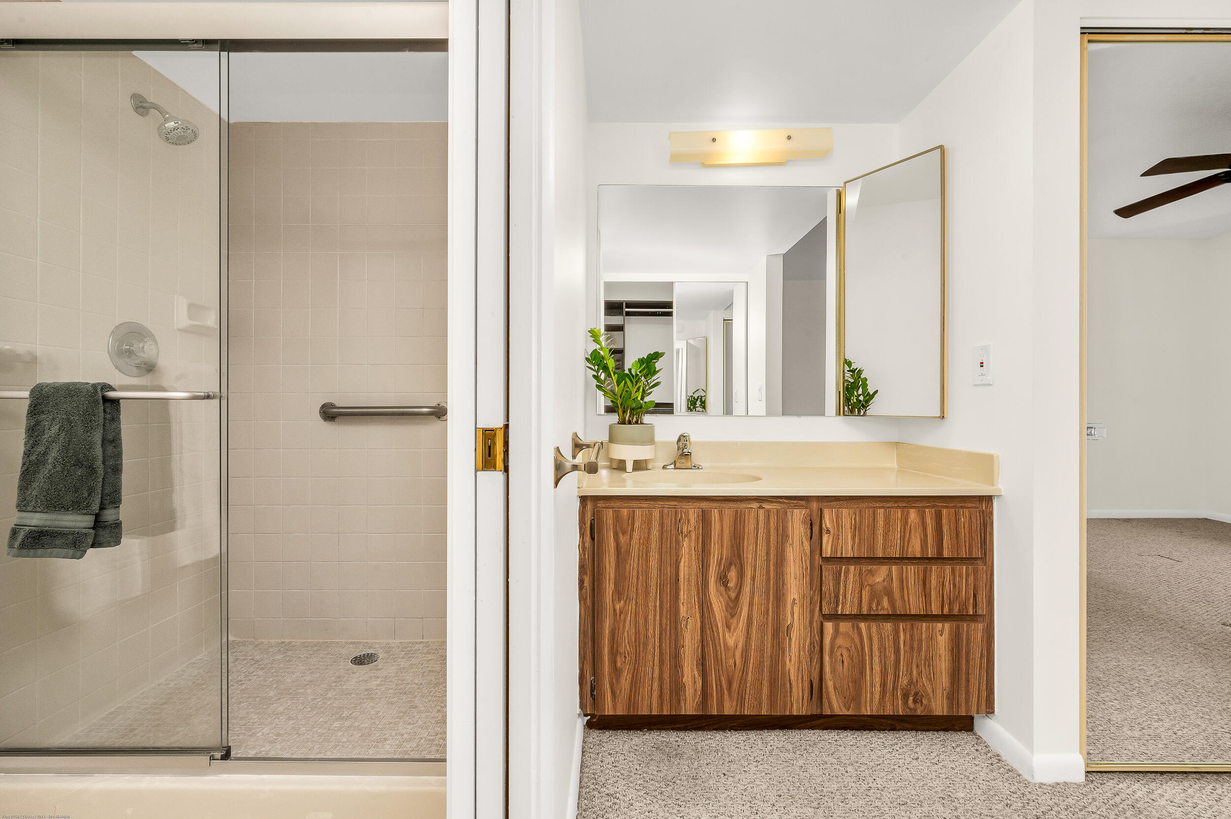 6121 Balboa Circle, Unit 202 Boca Raton, FL 33433 - Photo 8 of 17 a bathroom with a granite countertop sink a mirror and a shower