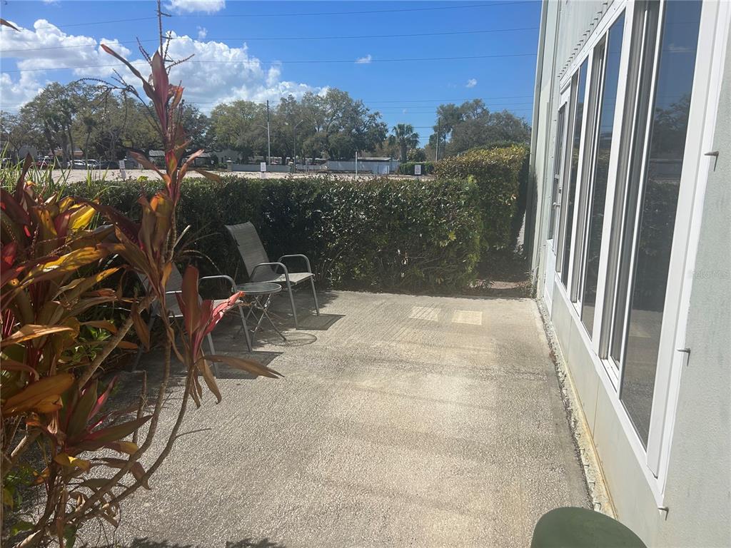 1433 South Belcher Road, Unit B7 Clearwater, FL 33764 - Photo 11 of 25 a terrace with outdoor seating and trees