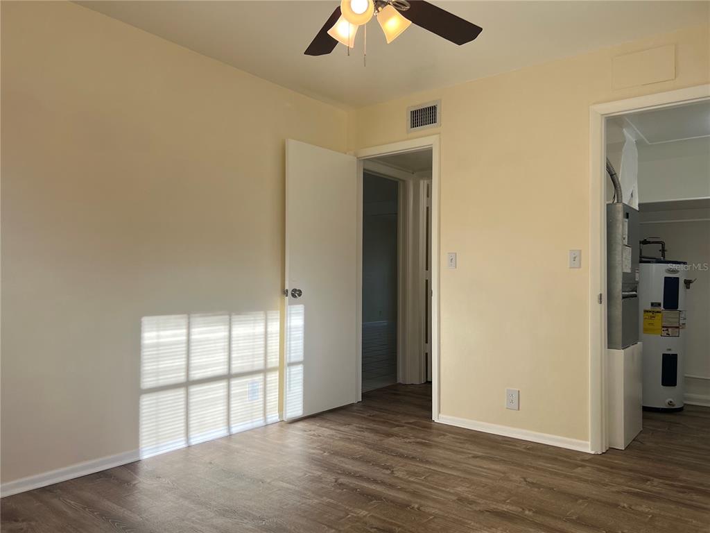 1433 South Belcher Road, Unit B7 Clearwater, FL 33764 - Photo 15 of 25 an empty room with wooden floor and windows