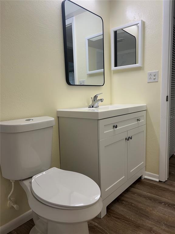 1433 South Belcher Road, Unit B7 Clearwater, FL 33764 - Photo 16 of 25 a bathroom with a toilet a sink and mirror