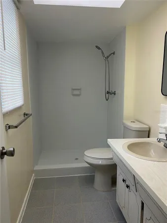 an empty room with wooden floor chandelier fan and closet