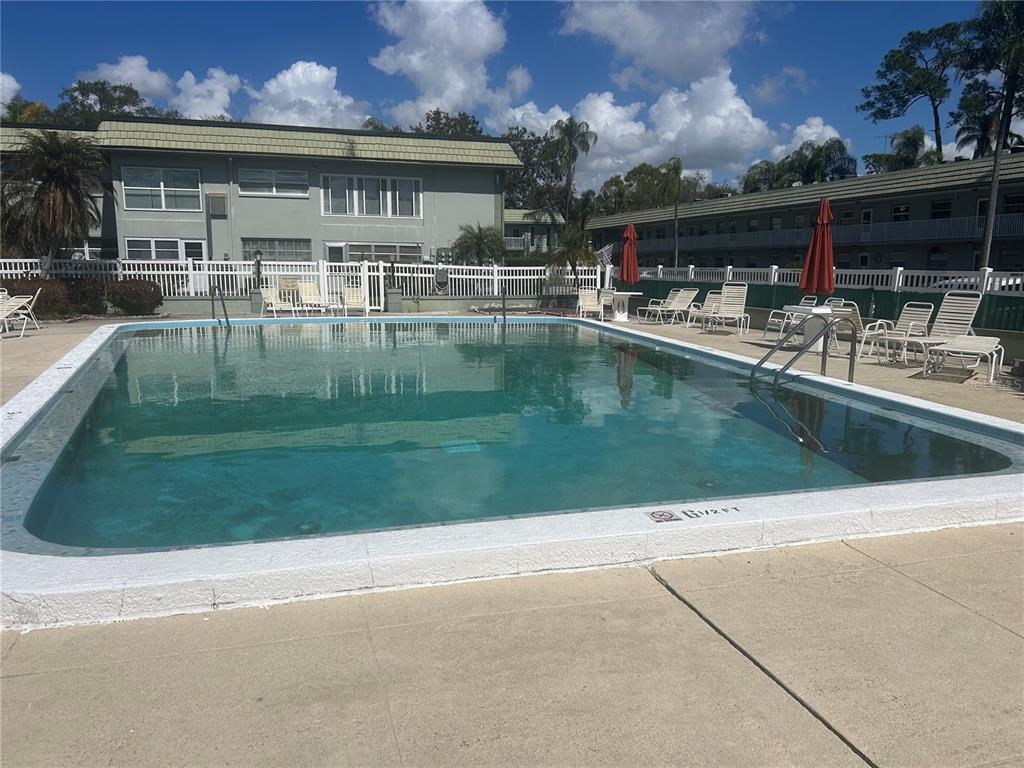 1433 South Belcher Road, Unit B7 Clearwater, FL 33764 - Photo 23 of 25 a view of a house with a swimming pool