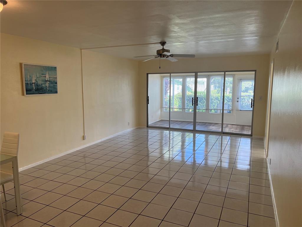 1433 South Belcher Road, Unit B7 Clearwater, FL 33764 - Photo 5 of 25 an empty room with wooden floor and windows