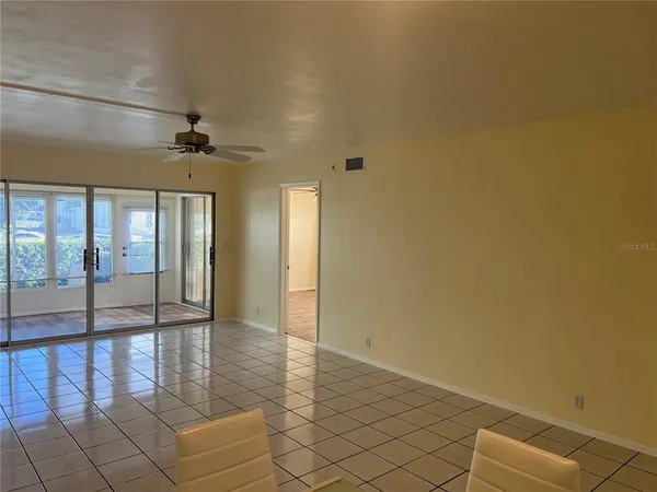 a view of a hallway with wooden floor and closet area