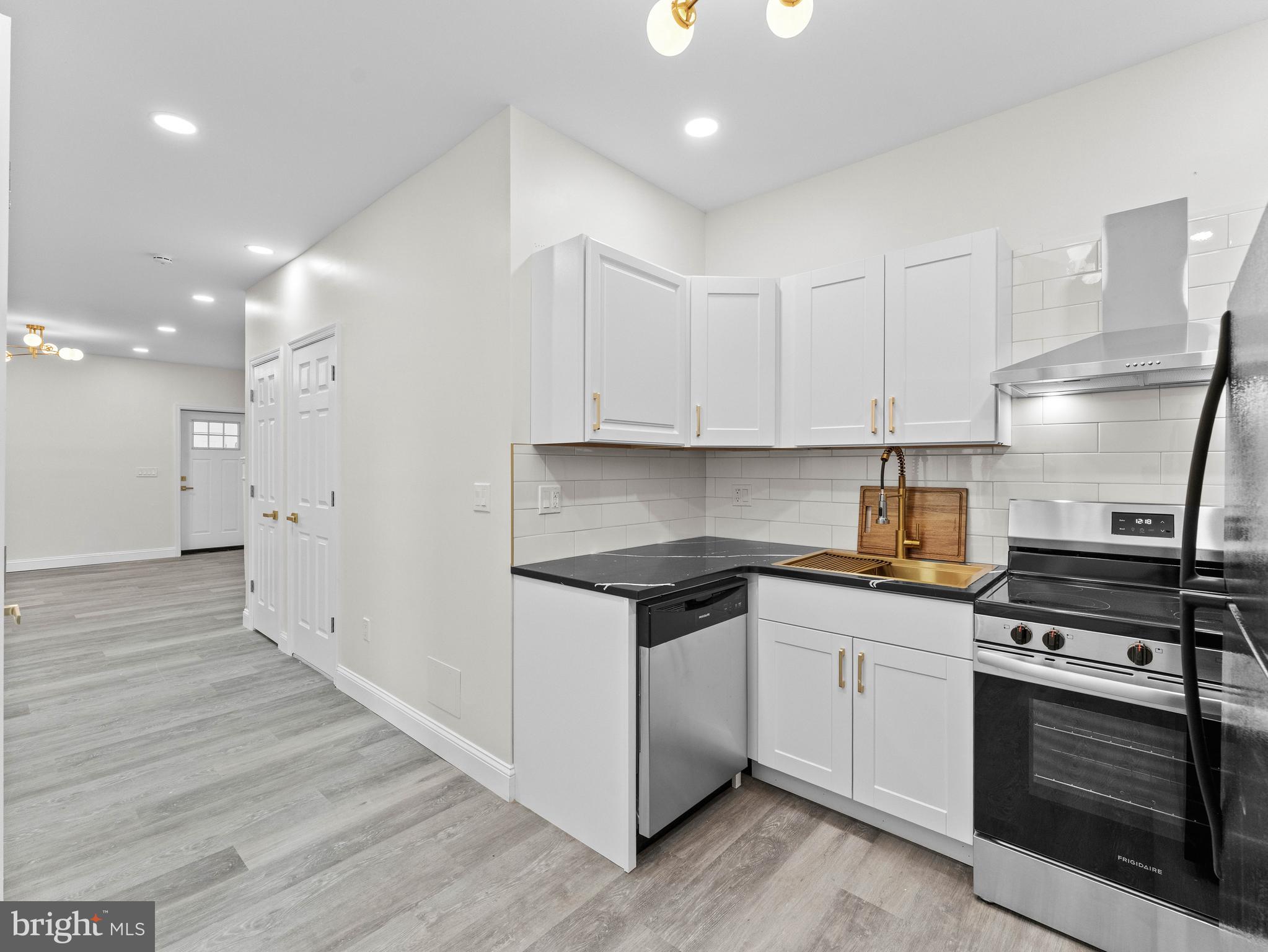 5422 Regent Street Philadelphia, PA 19143 - Photo 14 of 35 a kitchen with granite countertop a stove and a sink