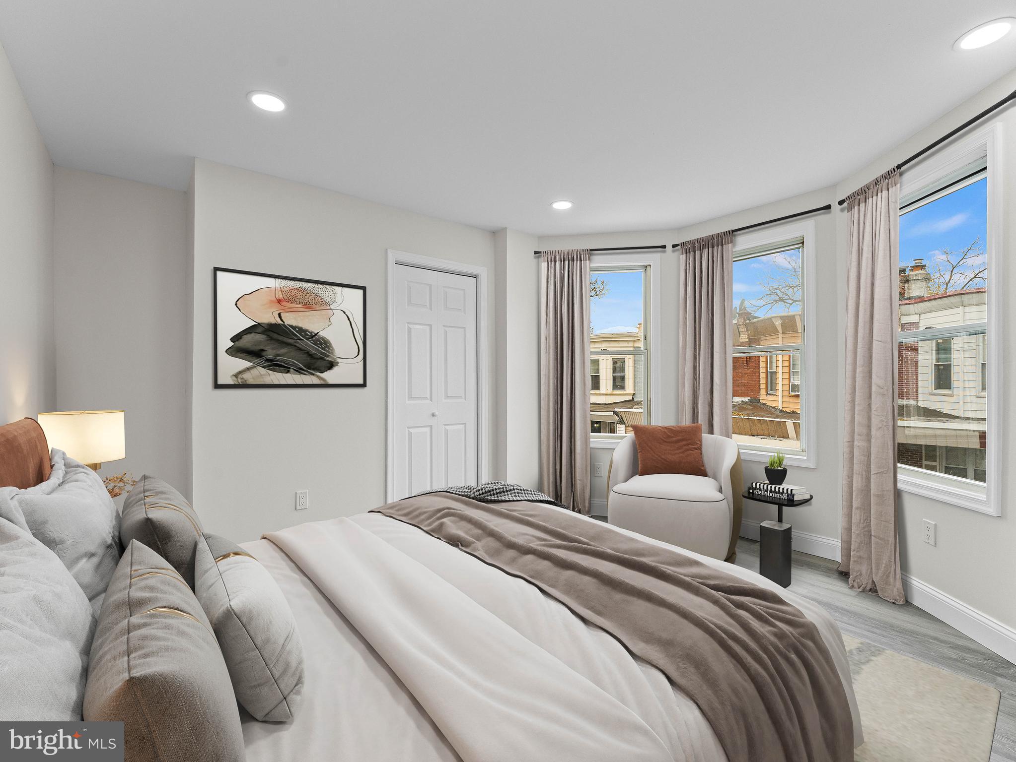 5422 Regent Street Philadelphia, PA 19143 - Photo 18 of 35 a bedroom with a large bed and a couch
